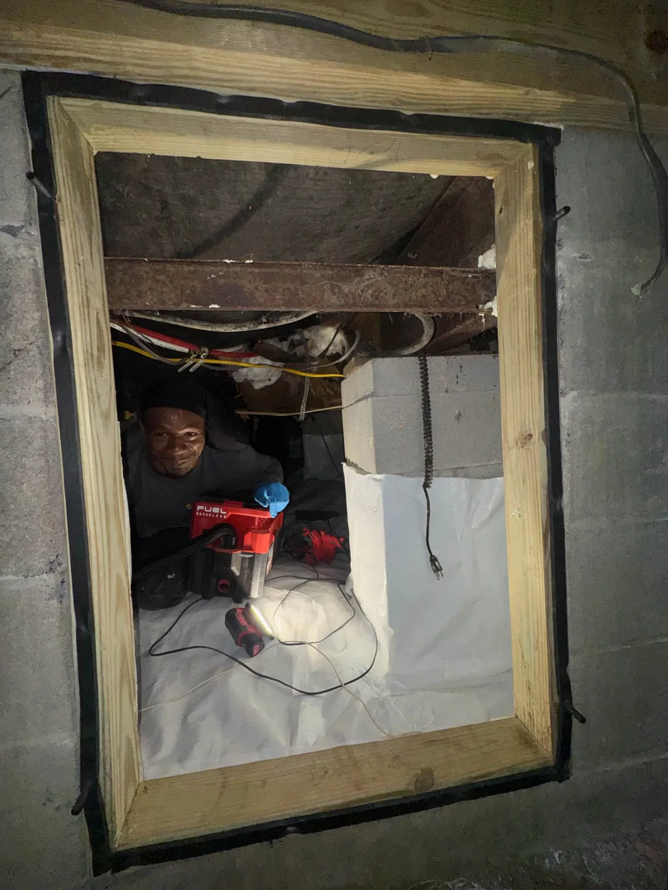 A Warren Mechanical technician working on equipment inside a real jobsite